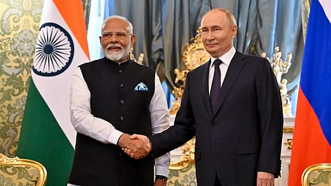 Russian President Vladimir Putin and Indian Prime Minister Narendra Modi shake hands during a meeting at the Kremlin in Moscow, Russia