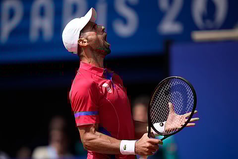 Serbia's Novak Djokovic reacts after awinning a point against Spain's Carlos Alcaraz during the men's singles tennis final at the Roland Garros stadium during the 2024 Summer Olympics, Sunday, Aug. 4, 2024, in Paris, France.
