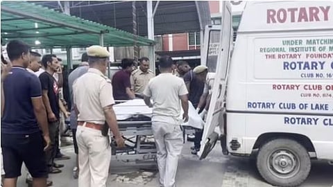 Police personnel shift injured people to a hospital in Imphal after Sunday attack