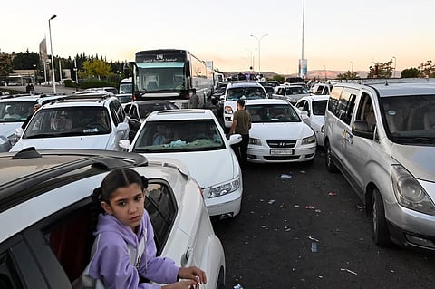 People fleeing from Lebanon arrive in Syria