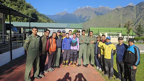 The Indian Air Force and the State Disaster Response Force (SDRF) team with mountaineers, Michelle Theresa and Favgane Manners.