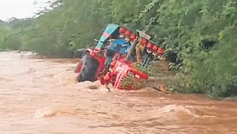 A tractor washed away in rain water at Gajjuganahalli village on Tuesday