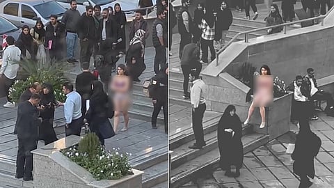 Iranian university student strips in protest