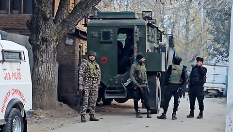 Security personnel stand guard during an encounter with terrorists at Sopore,