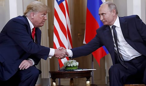 U.S. President Donald Trump, left, and Russian President Vladimir Putin shake hands.