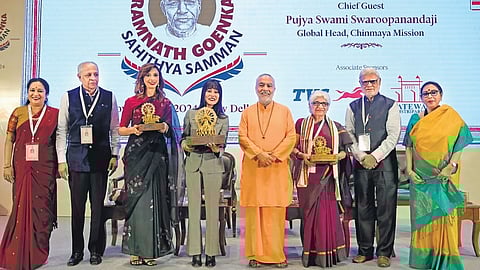 Ramnath Goenka Sahithya Samman awardees Ruskin Bond (represented by granddaughter Srishti), who was conferred the Lifetime Achievement Award (4th from L), Non-fiction award winner Neerja Chowdhury (6th from L) and Fiction award winner Aishwarya Jha (3rd from L) with (from L) TNIE CEO Lakshmi Menon, TNIE CMD Manoj Kumar Sonthalia, Chinmaya Mission global head Swami Swaroopanandaji, TNIE Editorial Director Prabhu Chawla, and TNIE Editor Santwana Bhattacharya, in New Delhi on Friday.Photo | Shekhar Yadav