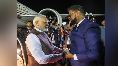 Prime Minister Narendra Modi being welcomed by Guyana President Mohamed Irfaan Ali upon his arrival at the airport in Georgetown, Guyana, on Wednesday.
