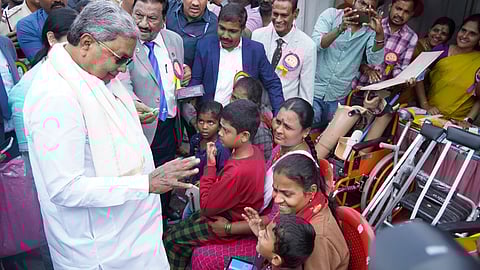Chief Minister Siddaramaiah with Persons with Disabilities during the International Day of Persons with Disabilities at Kanteerava Stadium, in Bengaluru on Tuesday.