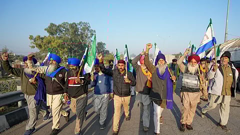 Farmers raise slogans as they gather at Shambhu border ahead of their 'Delhi Chalo' march to the national capital, in Patiala district, Punjab, Friday, Dec. 6, 2024.