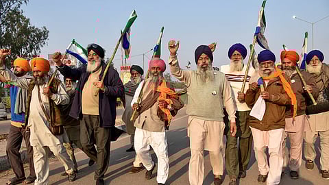 Farmers raise slogans as they gather at the protest site at Shambhu Border before the start of their march towards Delhi, in Patiala district, Sunday.