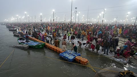 Devotees take a holy dip in the Ganga river on the first day of Maha Kumbh Mela 2025, in Prayagraj, Uttar Pradesh, Monday.