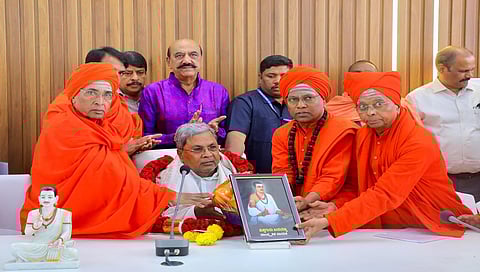 Lingayat seers present a portrait of Basavanna to CM Siddaramaiah