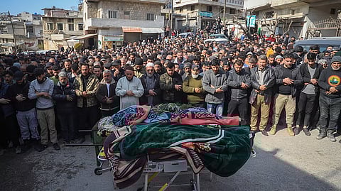 Village male residents pray during the funeral of four Syrian security force members killed in clashes with loyalists of ousted President Bashar Assad in coastal Syria, in the village of Al-Janoudiya, west of Idlib, Saturday, March 8, 2025.