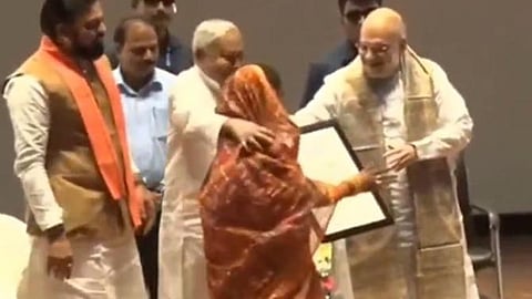 Nitish Kumar puts arm around woman's shoulders