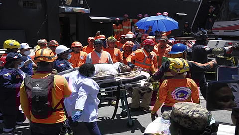 Rescue workers carry a person pulled from the wreckage of the Jet Set nightclub a