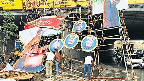 An unauthorised banner that fell on a car near Nagarabhavi Circle on Saturday