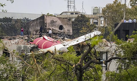 Remains of the crashed Air India plane lie on a building, in Ahmedabad, Friday, June 13, 2025