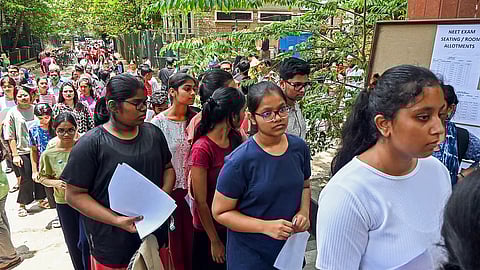 FILE | Aspirants wait to appear for the NEET UG exam, in Bengaluru