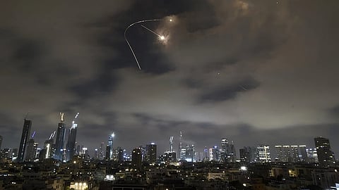 Israeli air defense system fires to intercept missiles during an Iranian attack over Tel Aviv, Israel, Saturday, June 21, 2025.