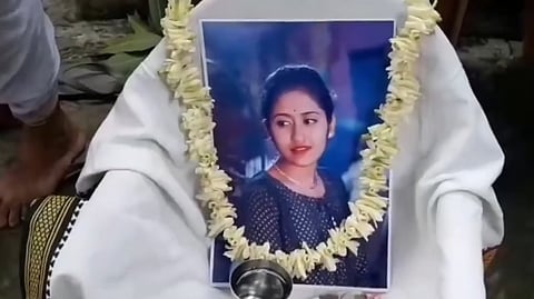 A garlanded photo of the woman