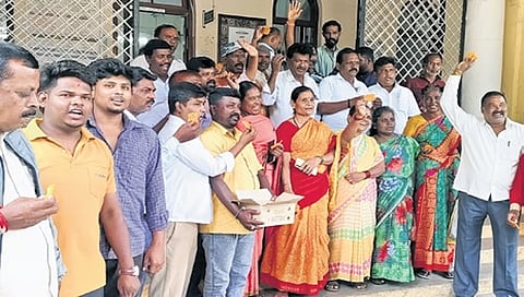 Pourakarmikas celebrate in front of the MCC office in Mysuru