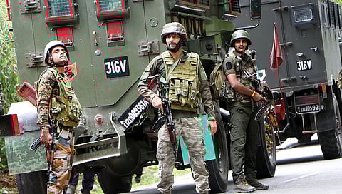 Army personnel stand guard at the encounter site