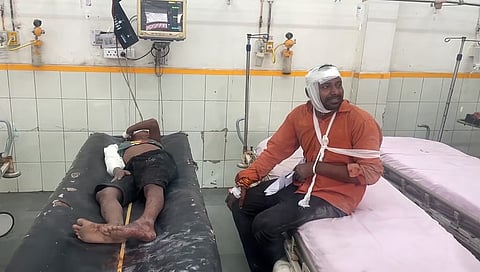Injured people undergo treatment at a hospital after a collision between a pick-up van