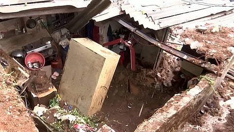 Soil and stones from a nearby hillock collapsed on a hut