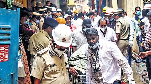 Firemen and volunteers carry out rescue operations from the plastic articles manufacturing unit, where a fire broke out, in Nagarathpete