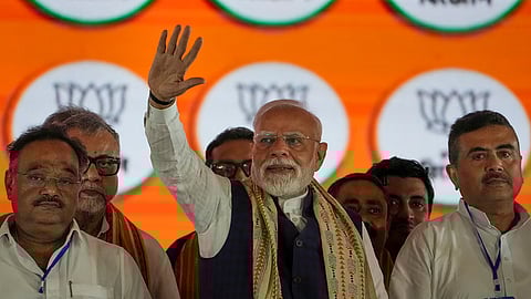 PM Modi with West Bengal BJP President Samik Bhattacharya and LoP in the West Bengal Assembly and BJP leader Suvendu Adhikari during a public meeting in Kolkata.