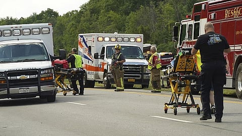 Rescue personnel work the scene of a tour bus
