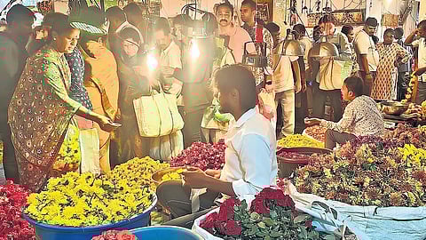 People make a beeline to purchase flowers ahead of Ganesha Chaturthi at KR Market on Sunday.