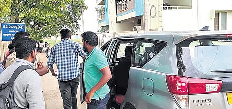 Directorate of Enforcement officials outside the residence of Chitradurga MLA KC Veerendra at Challakere, Chitradurga district, on Tuesday