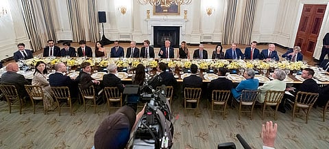 President Donald Trump points to a reporter to ask a question question during a dinner in the State Dinning Room of the White House,