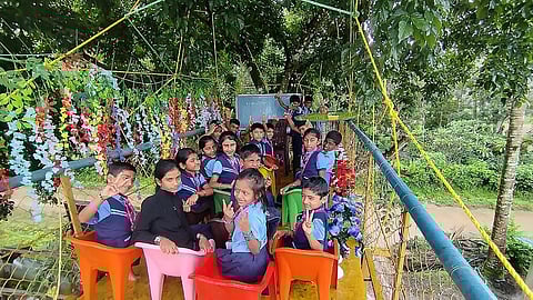 Nests of birds, insects, and blooming flowers add to the charm of this swing classroom,” the headmaster said