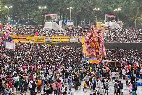 People take part in visarjan, immersion, of idols of Lord Ganesha during the 'Ganesh Chaturthi' festival, at Girgaon Chowpatty, in Mumbai