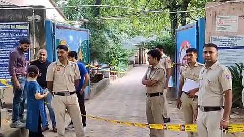Police personnel keep vigil outside Sarvodaya (Co-Ed) Senior Secondary school after it received a bomb threat, at Mehrauli, in New Delhi, Saturday