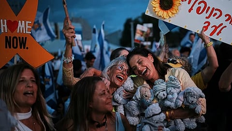 People gather prior to the release of Israeli hostages held in Gaza, at a plaza known as the hostages square in Tel Aviv, Israel, Monday, Oct. 13, 2025