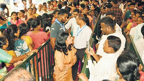 Hassan Deputy Commissioner KS Latha Kumari interacts with devotees standing in queue at Hasanamba Temple in Hassan on Monday