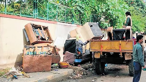 Discarded furniture being removed from a footpath in North City Corporation limits.