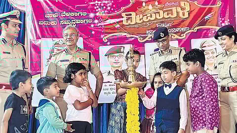 City Police Commissioner Seemant Kumar Singh and other top cops with children of police personnel: Right: Singh lights a sparkler