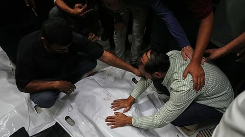 The bodies of Palestinians killed in an Israeli army strike are brought to Nasser Hospital