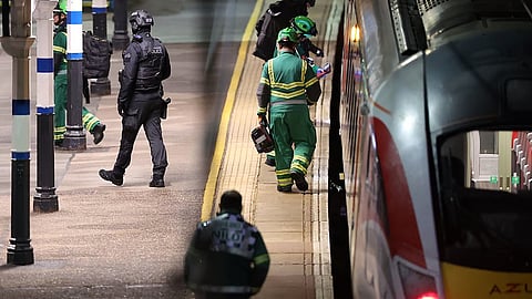 Emergency personnel inspect a train at the Huntingdon, England, train station in Cambridgeshire after people were stabbed Saturday, Nov. 1, 2025