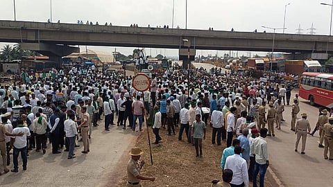 Farmers agitating near the Hattargi Toll Naka in Hukkeri taluk on Friday.