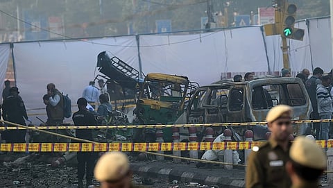 Charred remains of vehicles at a cordoned off area following a blast that occurred near Red Fort Metro Station on Monday, Nov 10, 2025, killing at least nine people