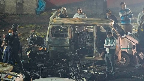 Security personnel at the spot after a blast occurred in a parked car near Red Fort, leaving multiple vehicles in flames.