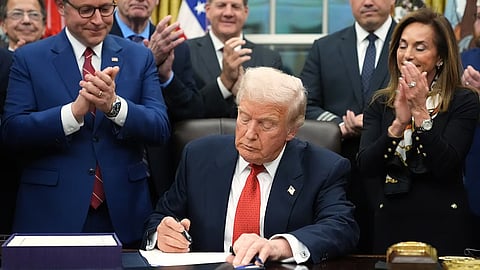 President Donald Trump signs the funding bill to reopen the government, in the Oval Office of the White House