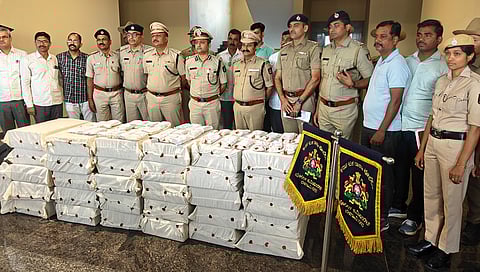 Belagavi police commissioner Bhushan Borse and his officials seen with the seized laptops from the Call Centre in Belagavi.