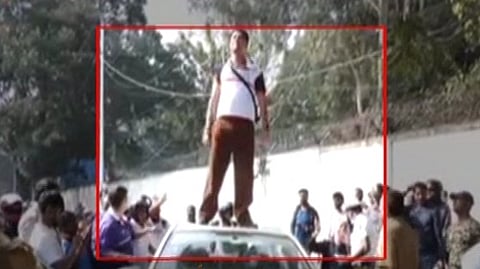A Passanger Standing on top of car