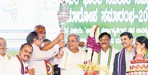 Chief Minister Siddaramaiah poses with a mace during the closing ceremony of the 72nd All-India Cooperation Week celebrations in Chamarajanagar on Thursday